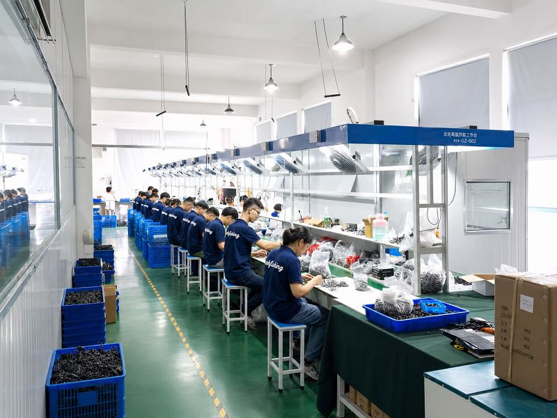 Workers assembling fishing reels on the factory production line Workers assembling fishing reels on the factory production line